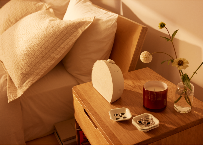 Hatch Restore 3 lifestyle — the device in context on a bedside table