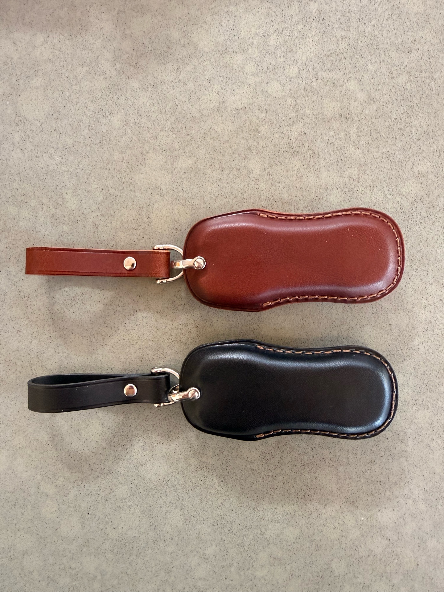 NUNOworkroom key fob covers — dark brown and black, back detail showing smooth leather
