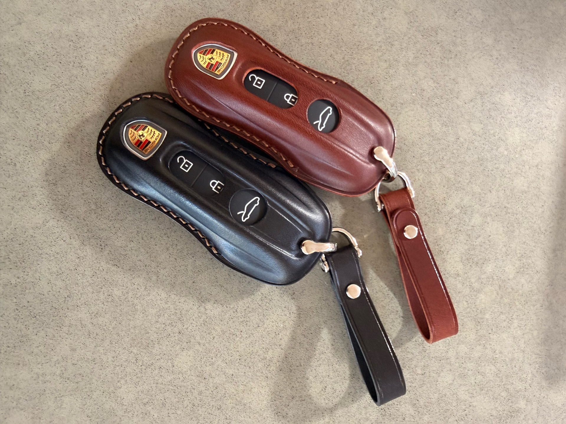NUNOworkroom Porsche key fob covers with keys inserted — dark brown and black