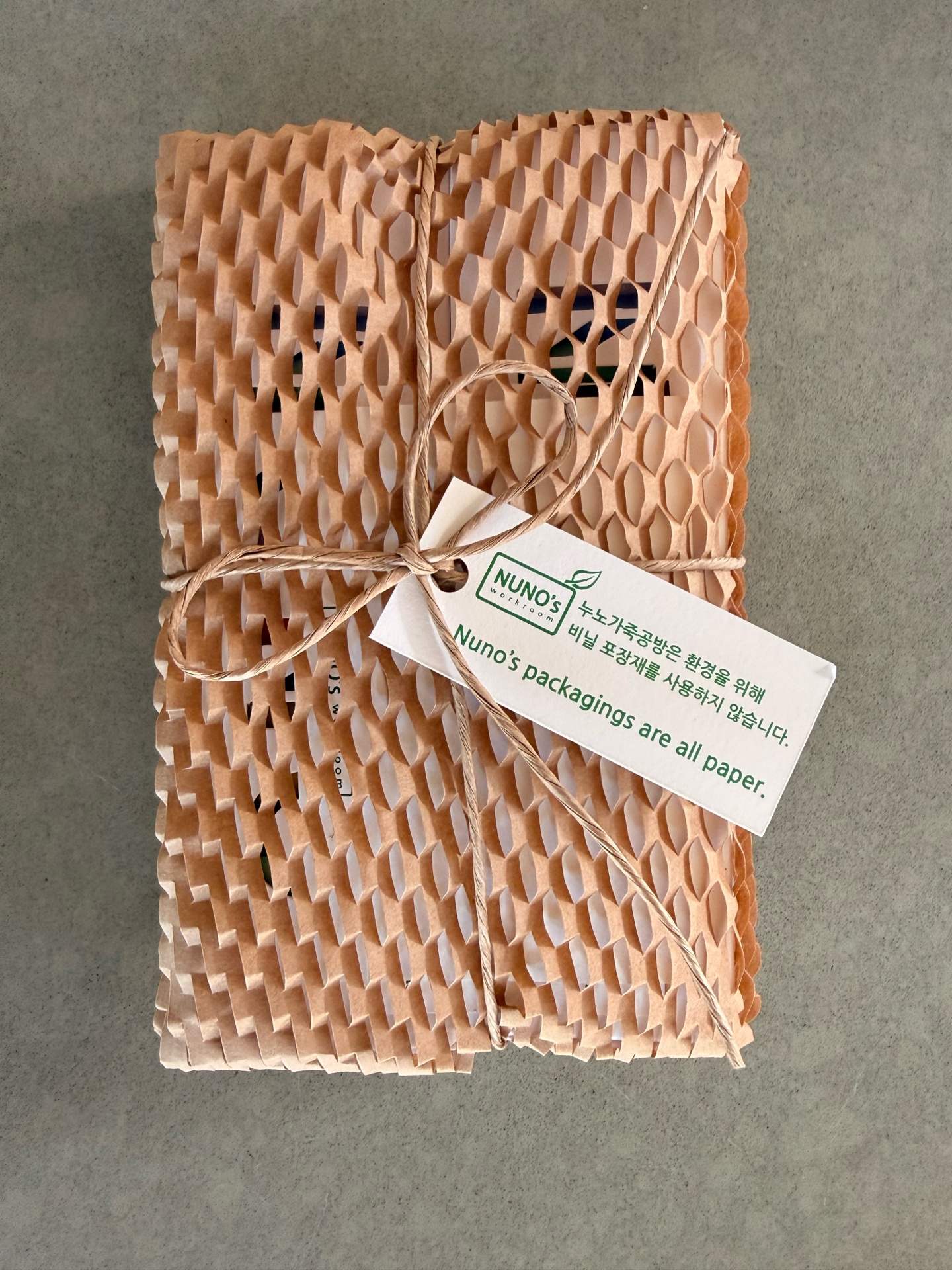 NUNOworkroom unboxing — honeycomb paper packaging with twine bow